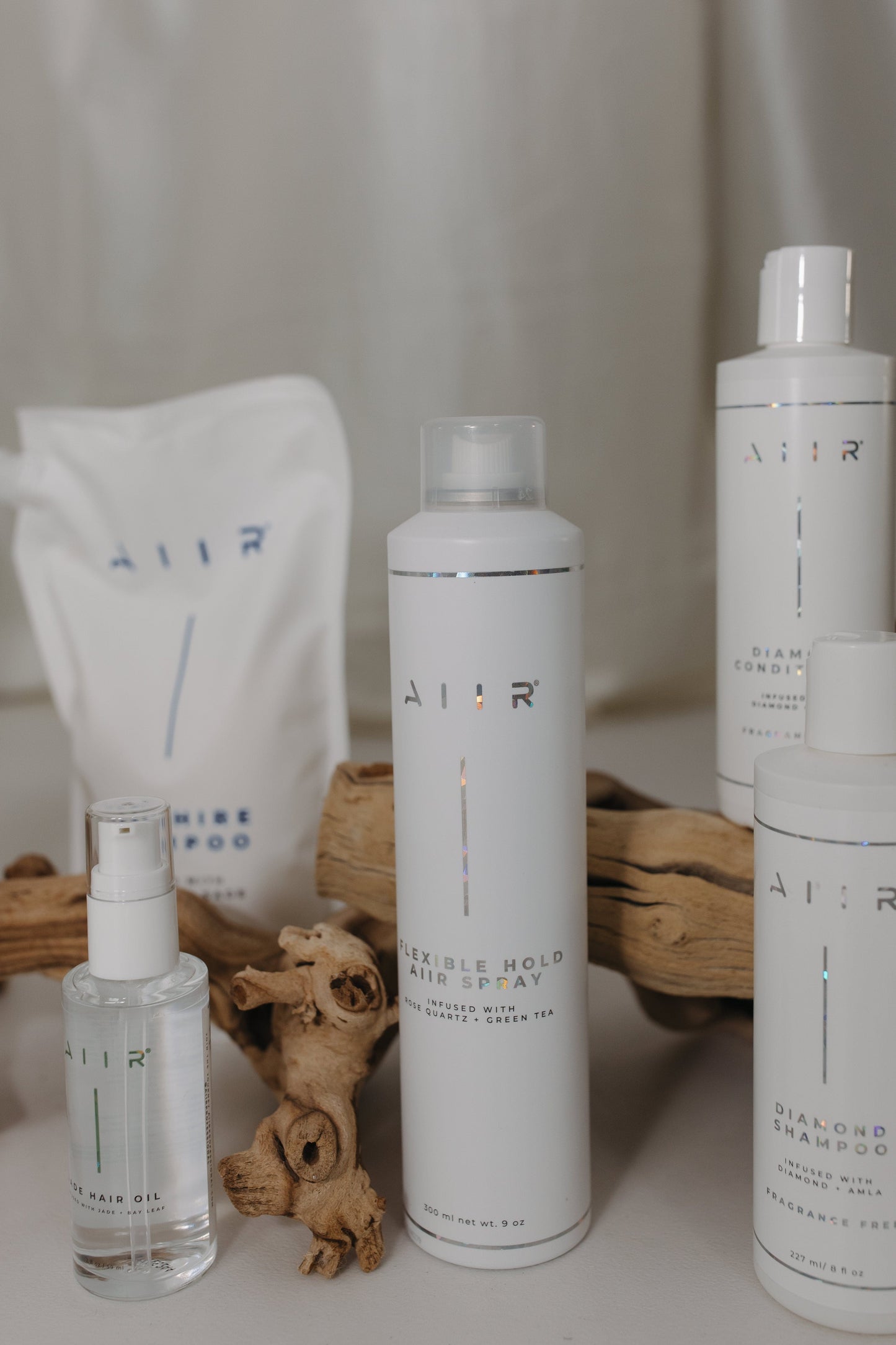Set of hair care products with 'Aler' branding on a neutral background