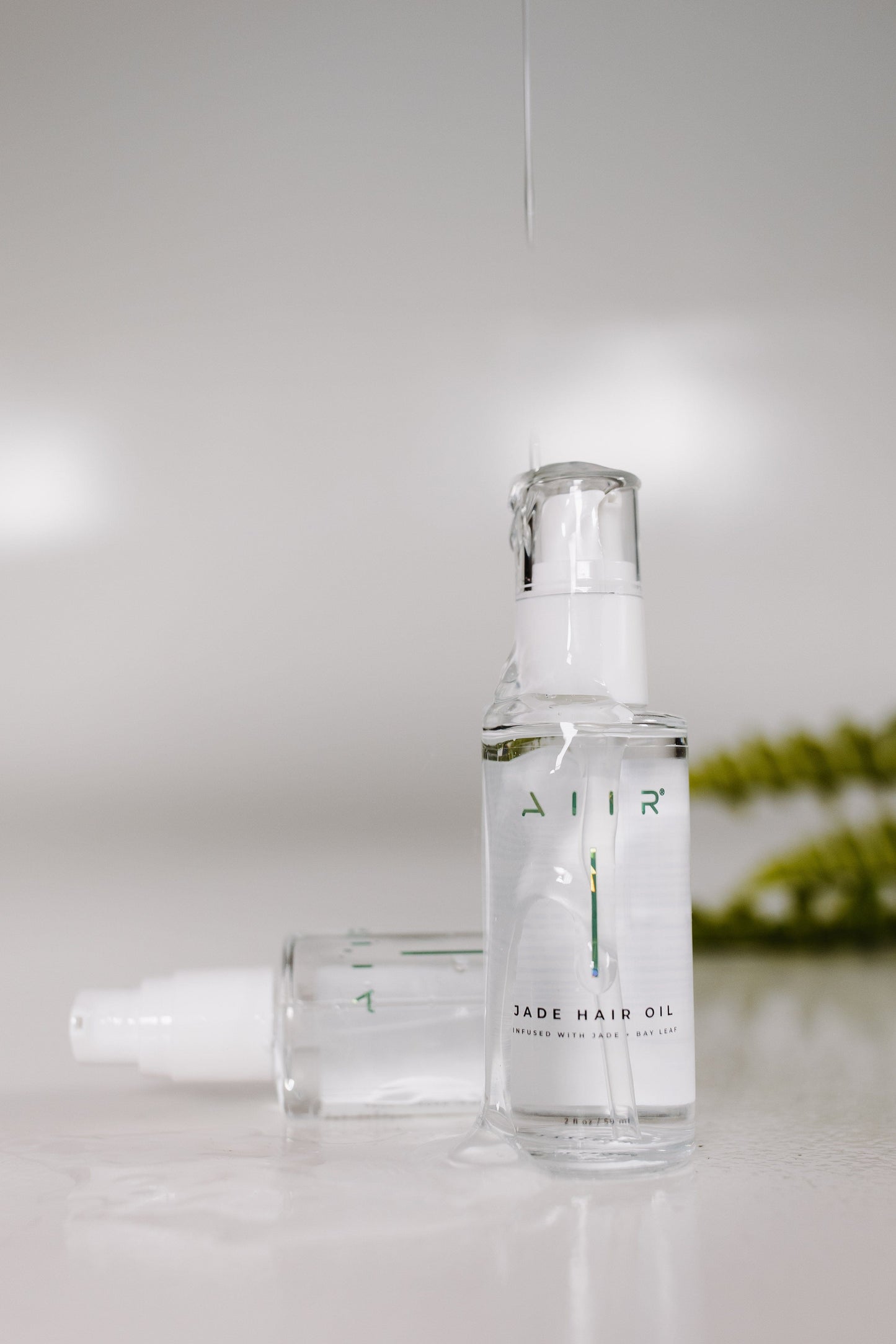 Clear bottle with white cap labeled 'AIR' on a light gray background