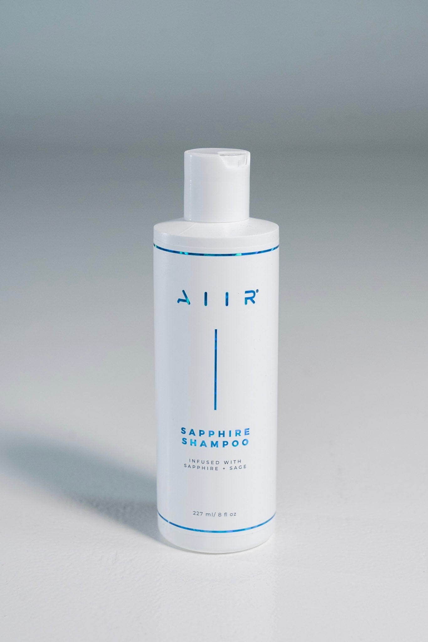 White shampoo bottle with 'AIR' branding on a gray background