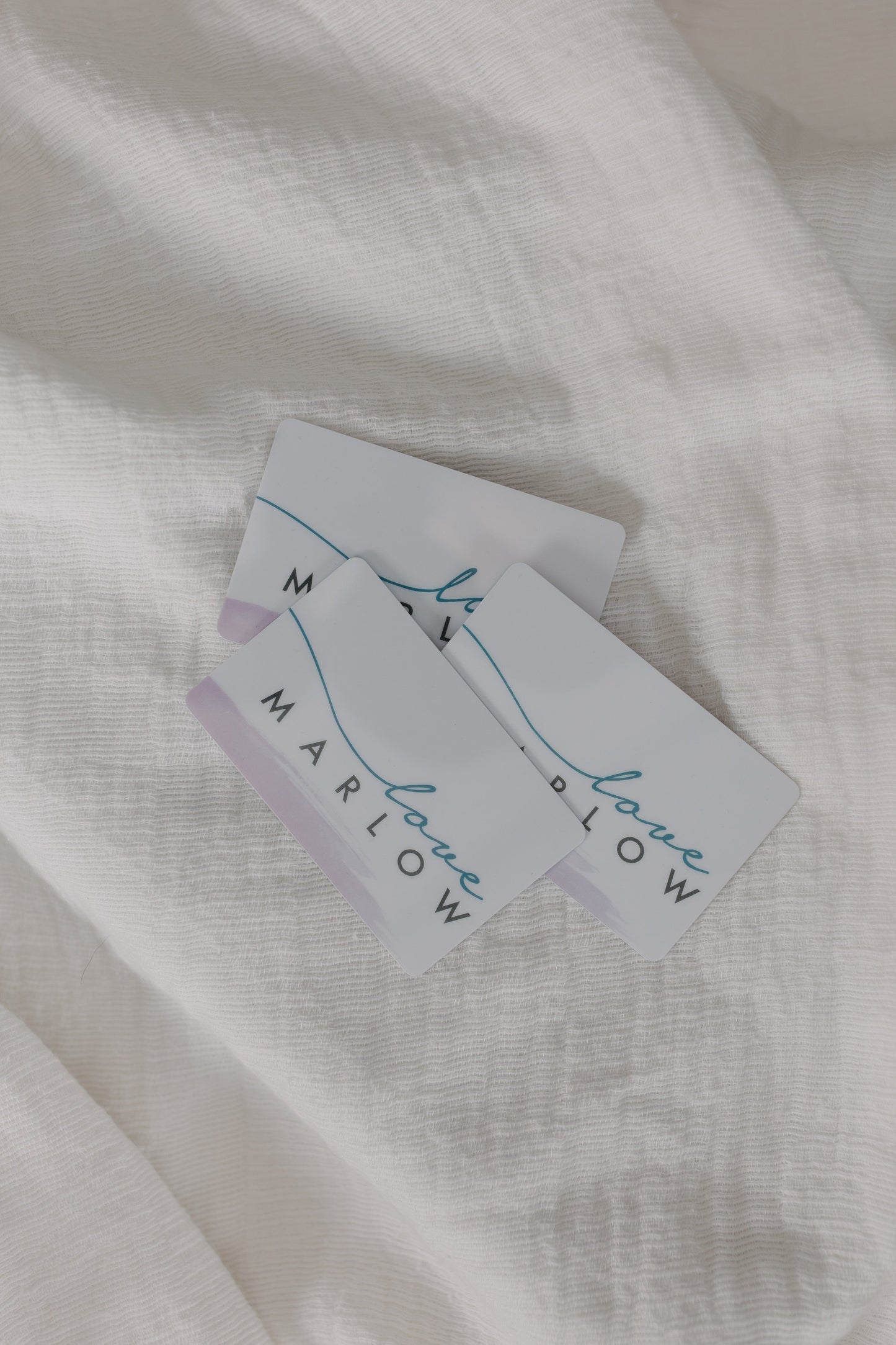 White fabric with 'Marlow' branded tags on a light background