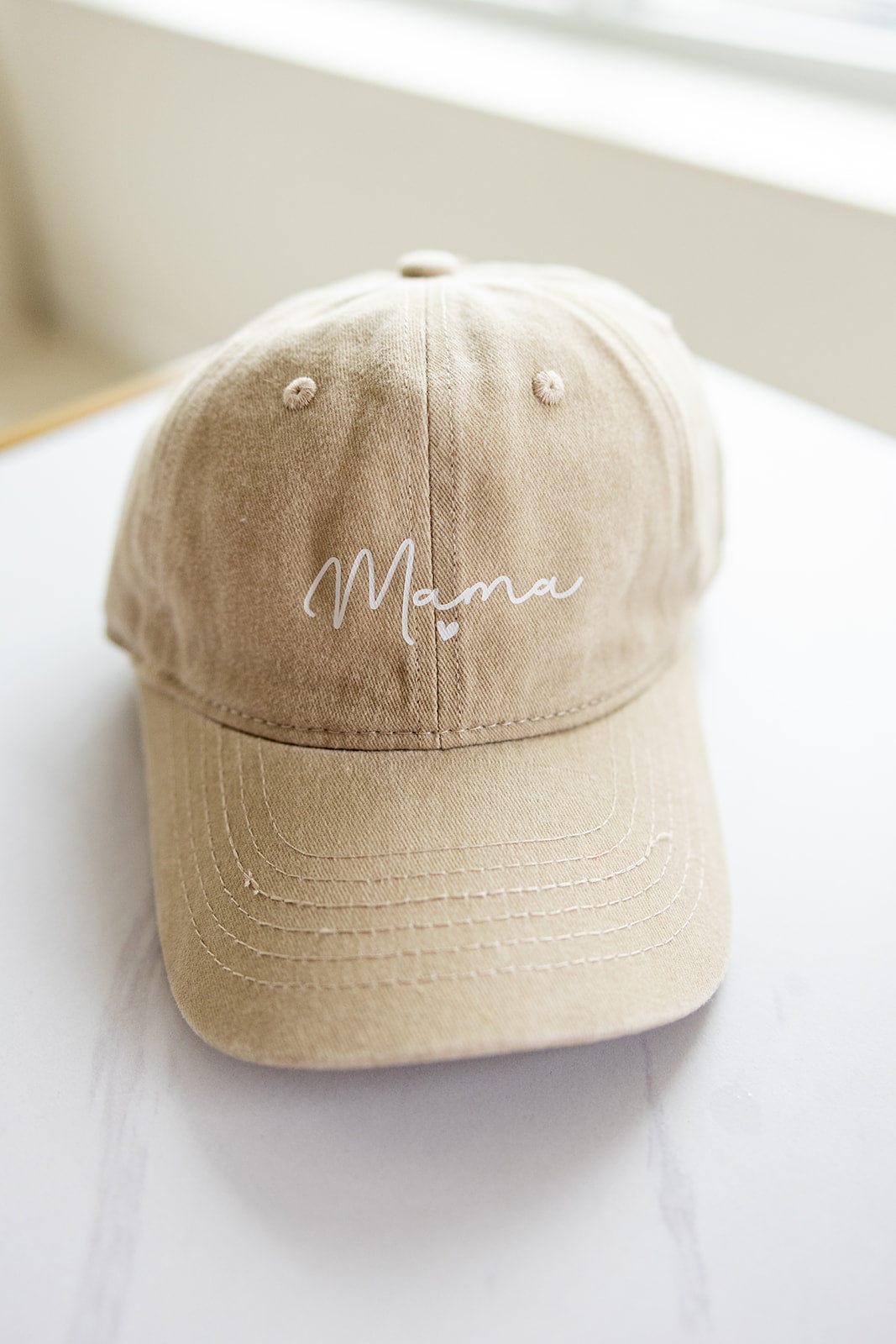 A beige MAMA Baseball Cap with