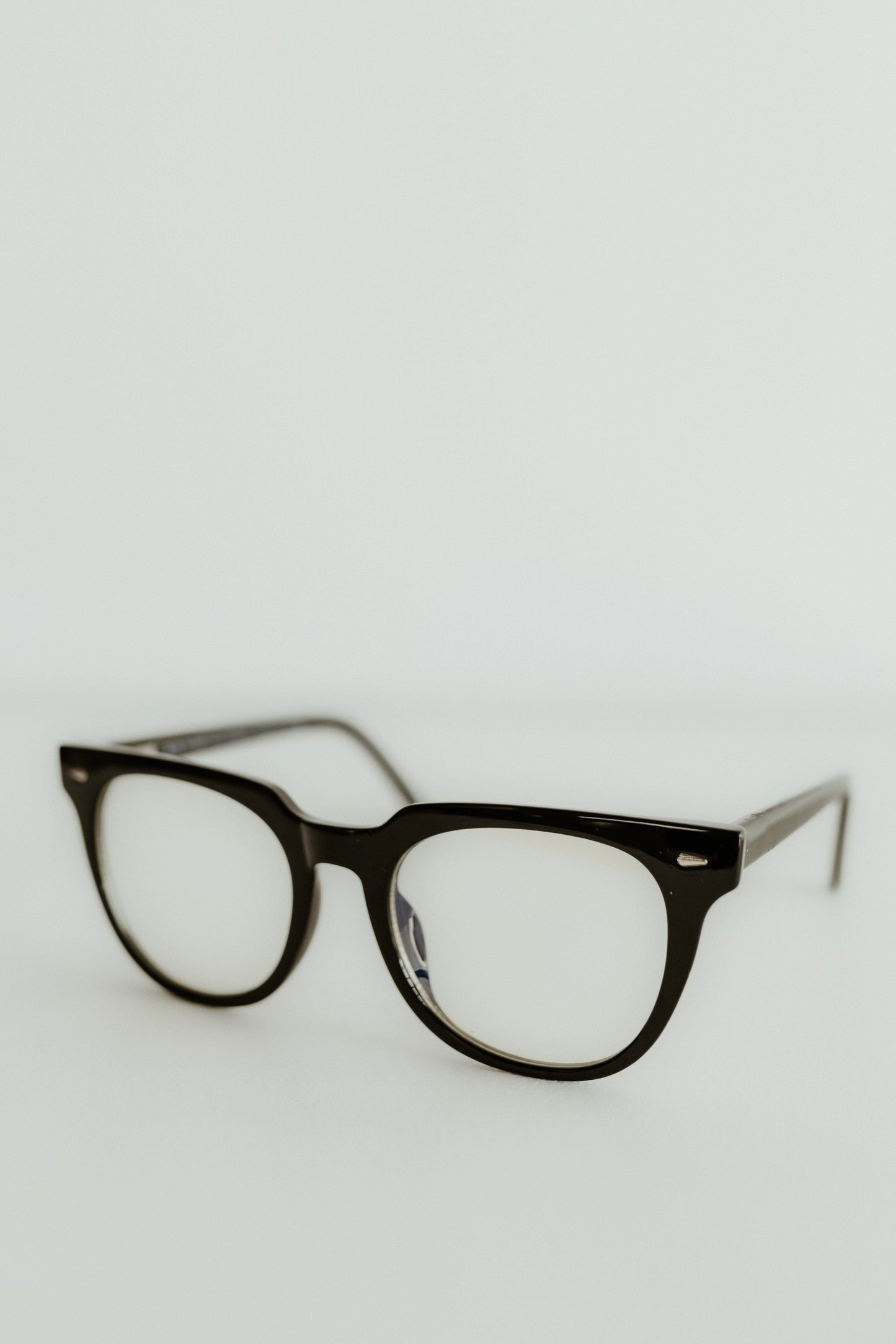 Black eyeglasses on a light gray background