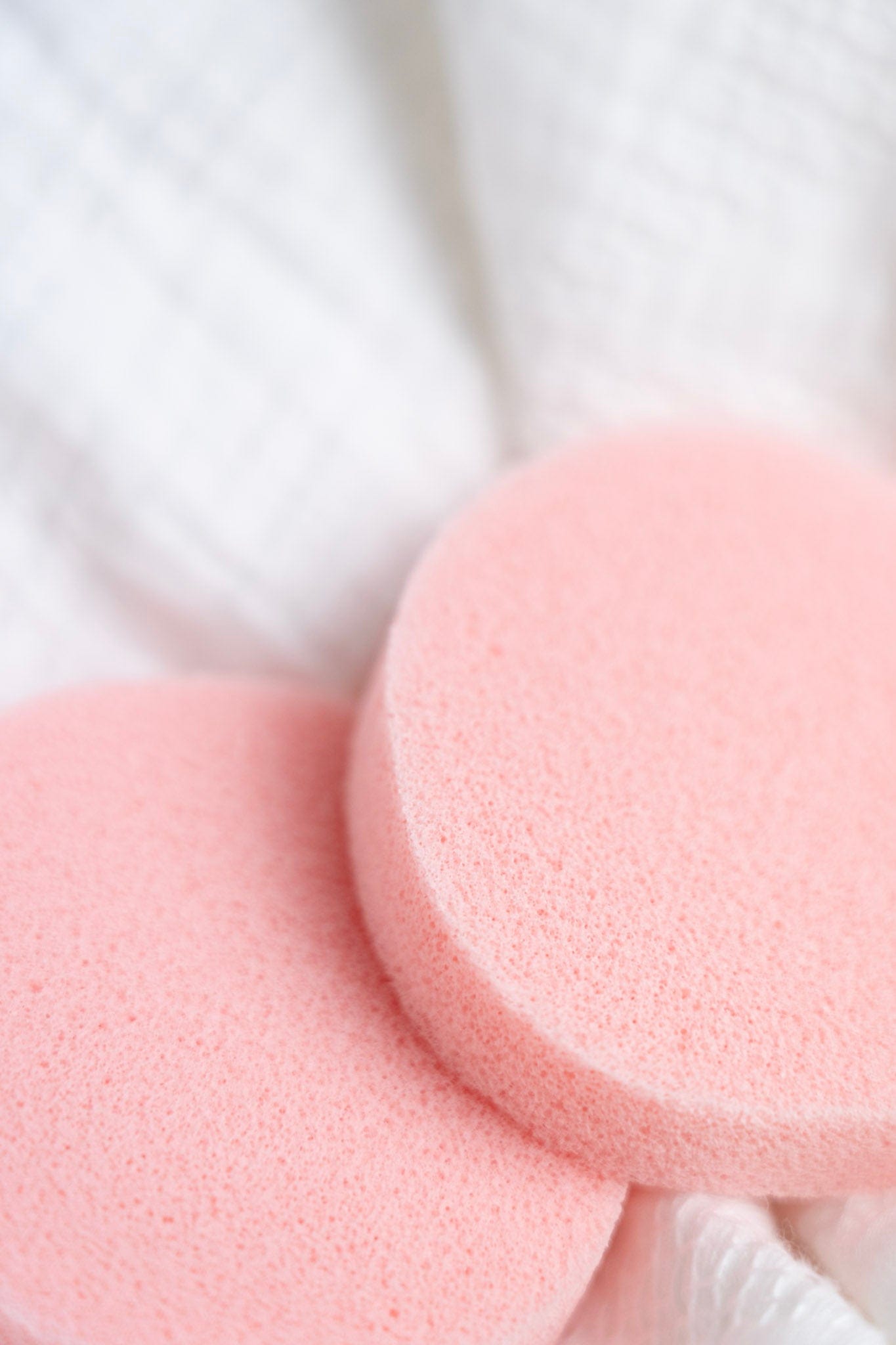 Close-up of pink deodorant removers on a white background