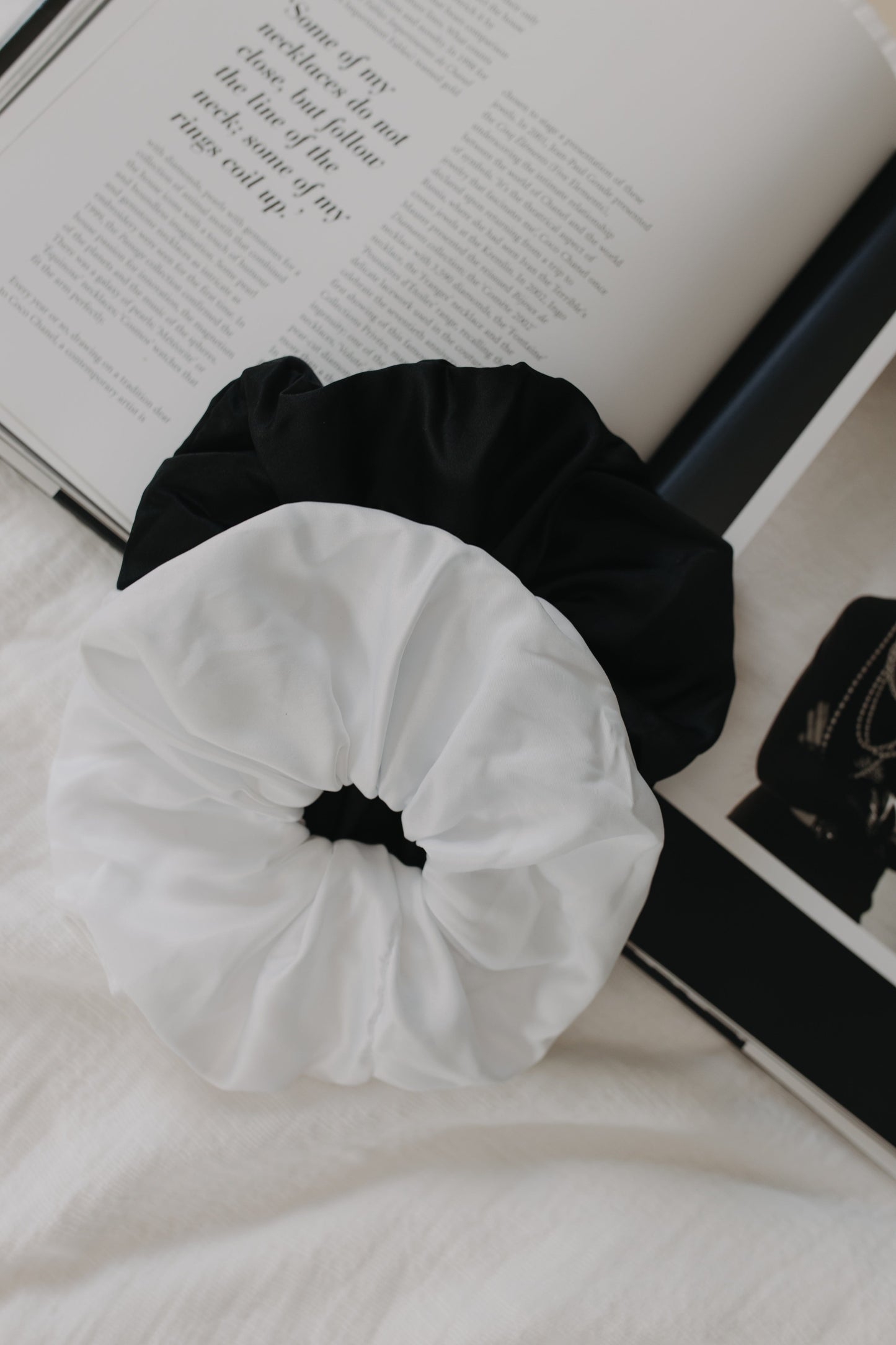Black and white scrunchies on an open book