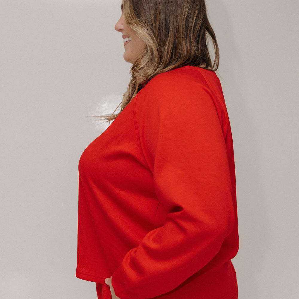 Person wearing a red outfit against a plain background