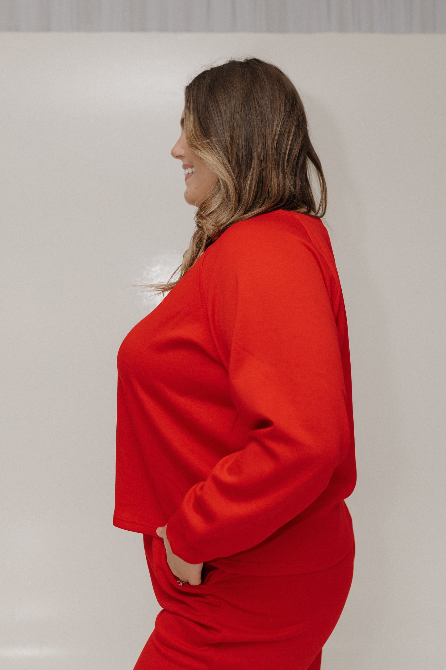 Person wearing a red outfit against a plain background