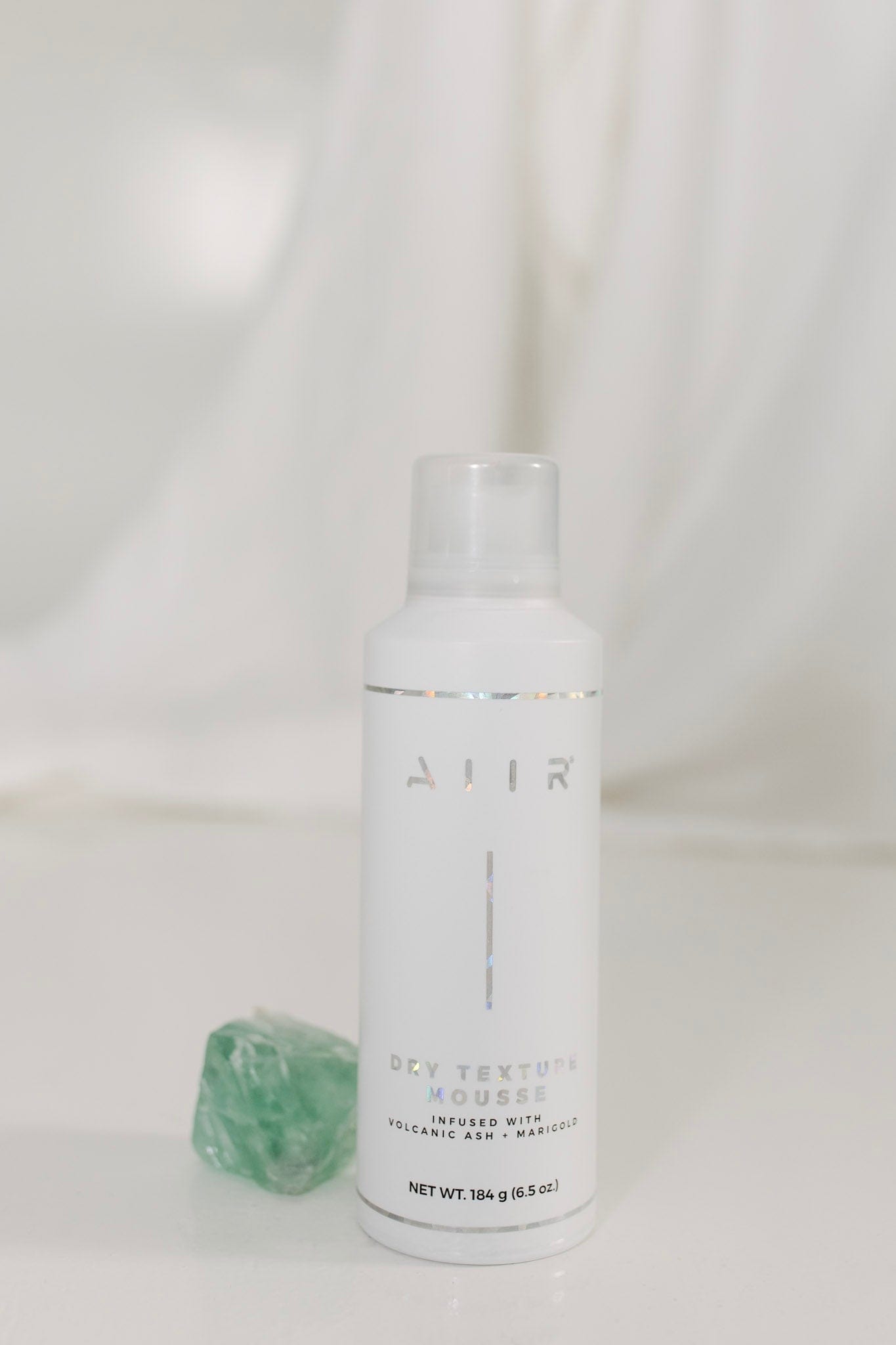White bottle with 'AIIR' branding on a white background