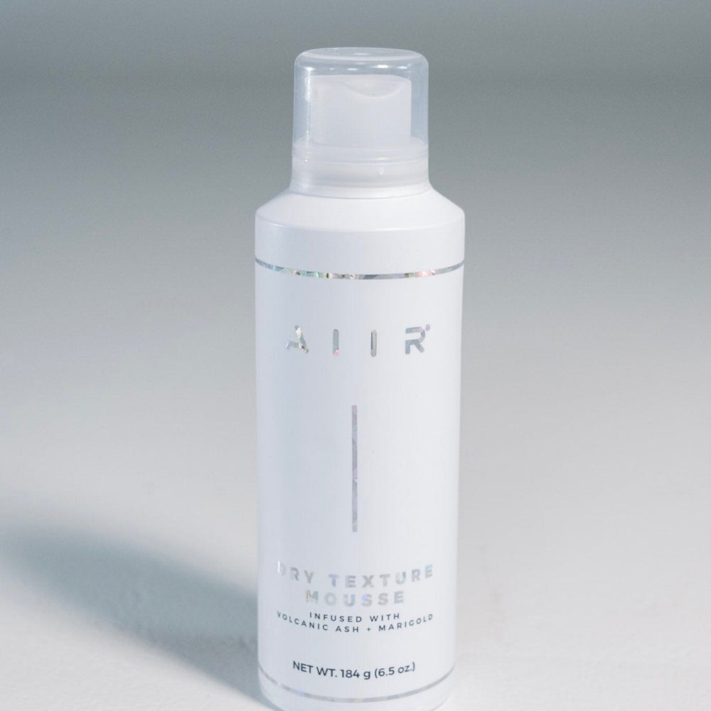 White bottle with 'AIR' branding on a gray background