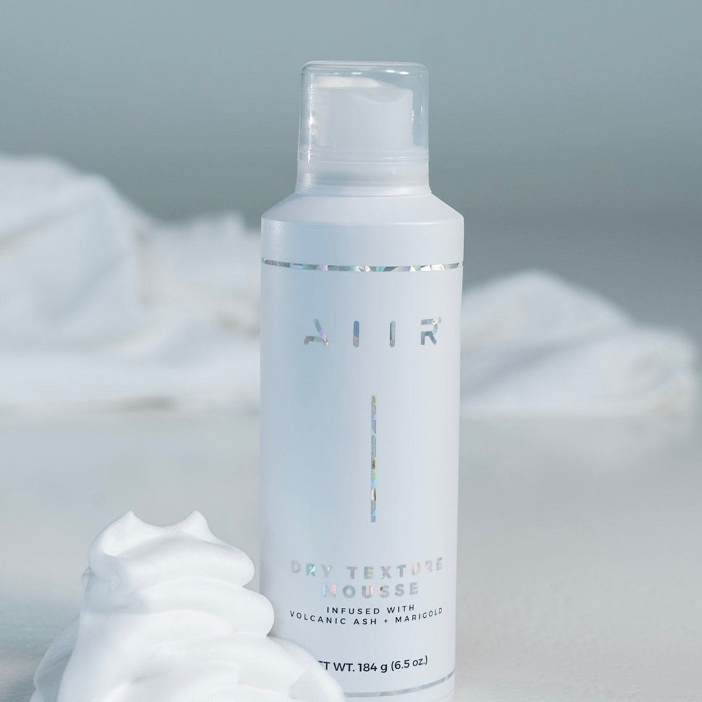 Skincare bottle labeled 'AIR' with white cream on a light gray background