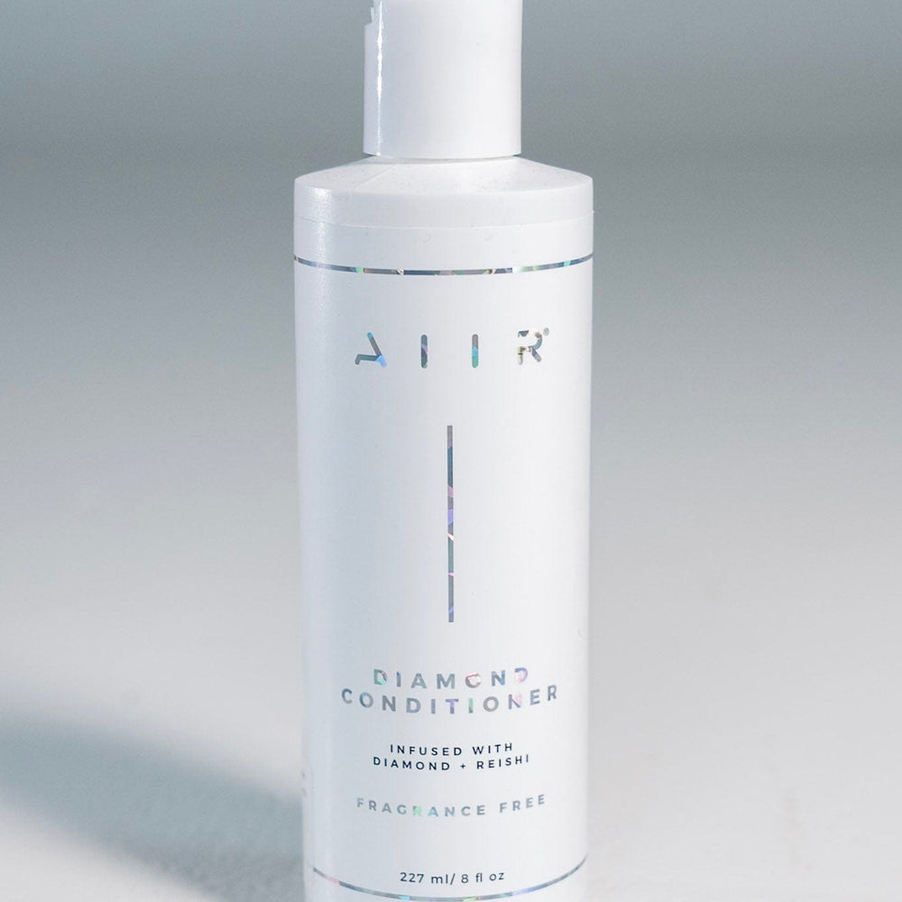 Bottle of 'AIIR' diamond conditioner on a gray background