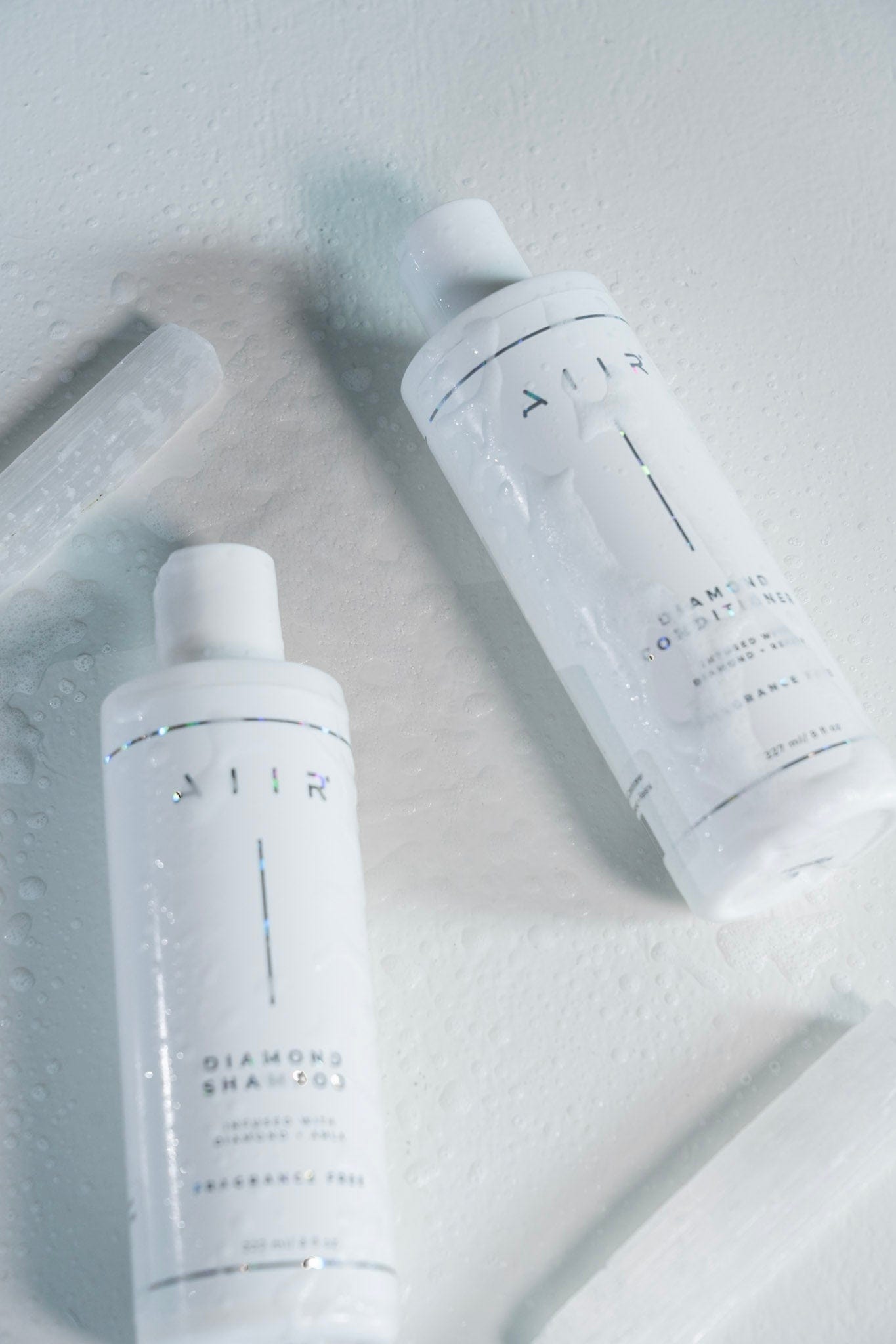 Two white shampoo bottles with 'AIR' branding on a light gray background