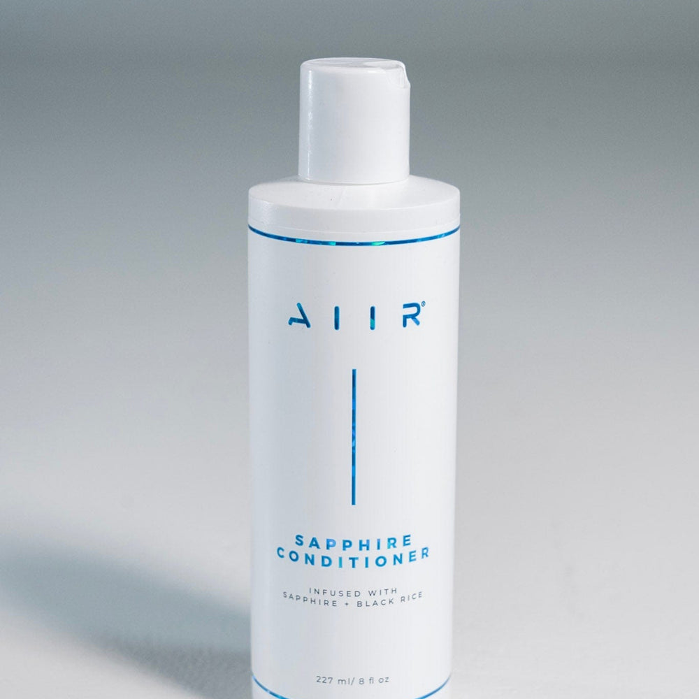 White bottle of AIIR Sapphire Conditioner on a gray background