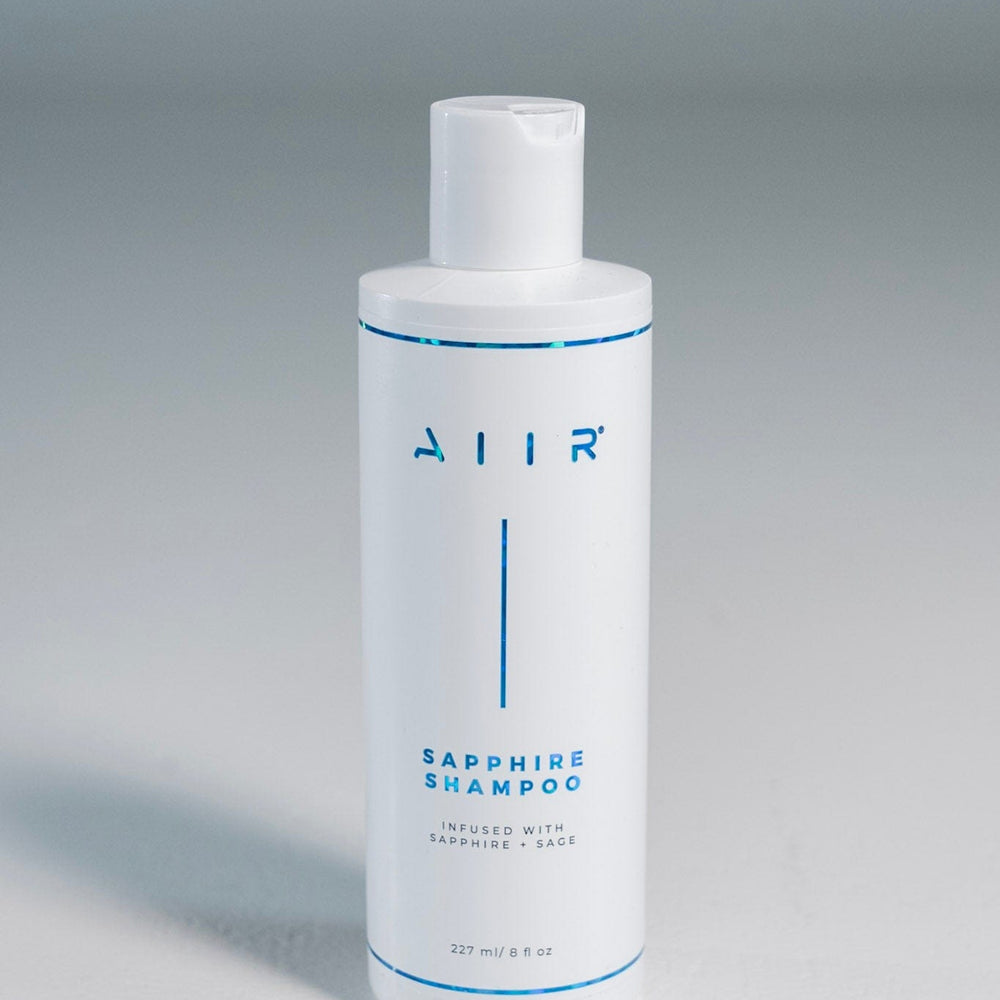 White shampoo bottle with 'AIR' branding on a gray background