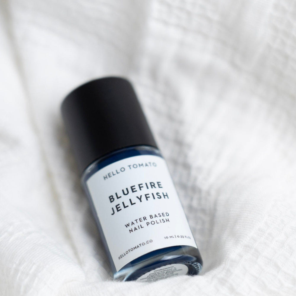 Bottle of Bluefire Jellyfish nail polish on a textured white surface