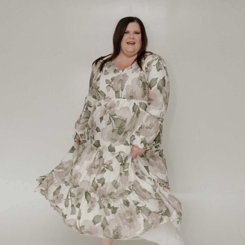 Woman wearing a floral dress against a white background