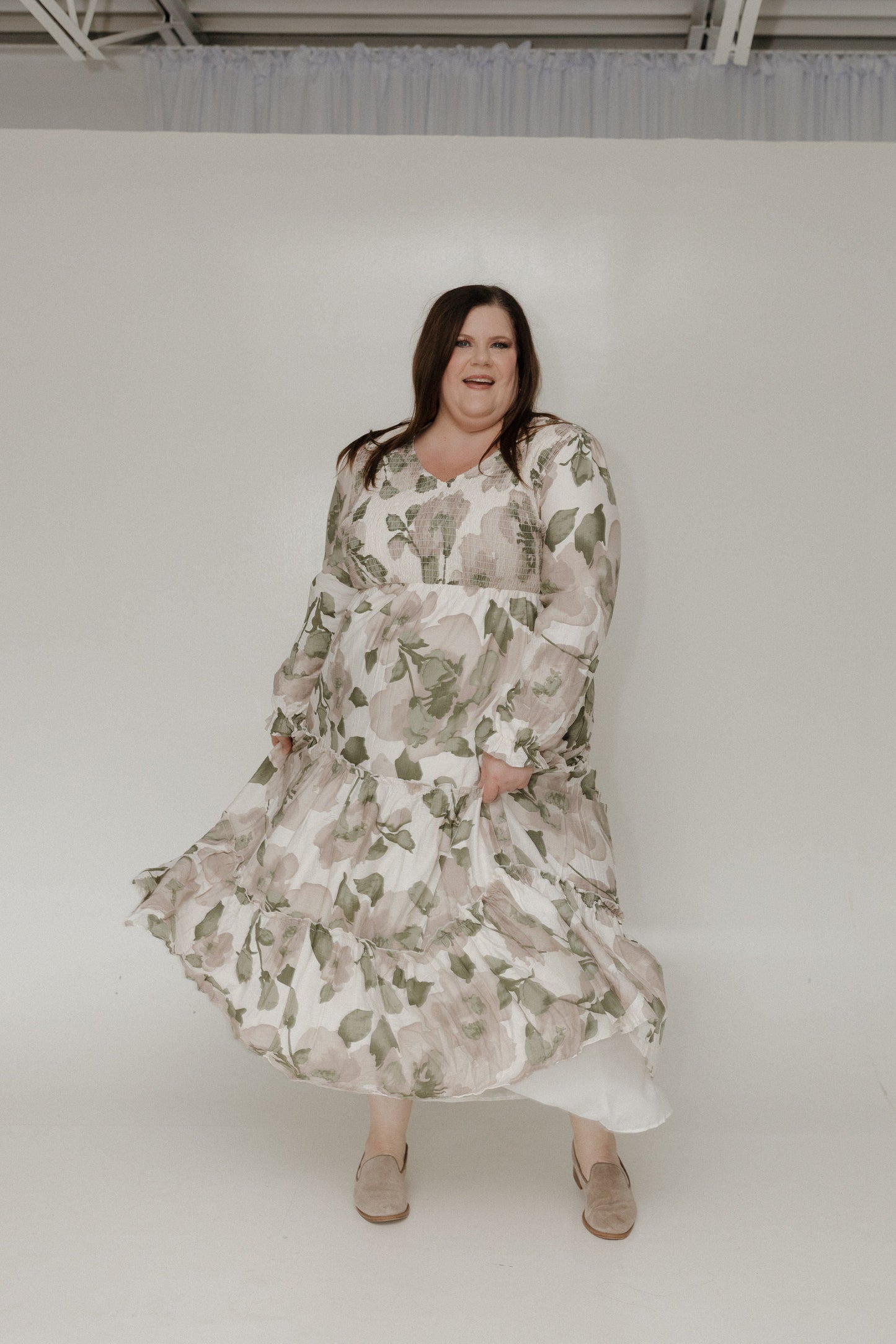 Woman wearing a floral dress against a white background