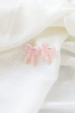 BOW STUDS IN BABY PINK