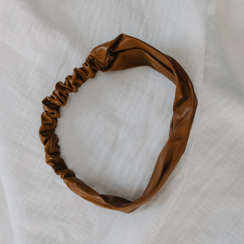 Brown headband on a white fabric background