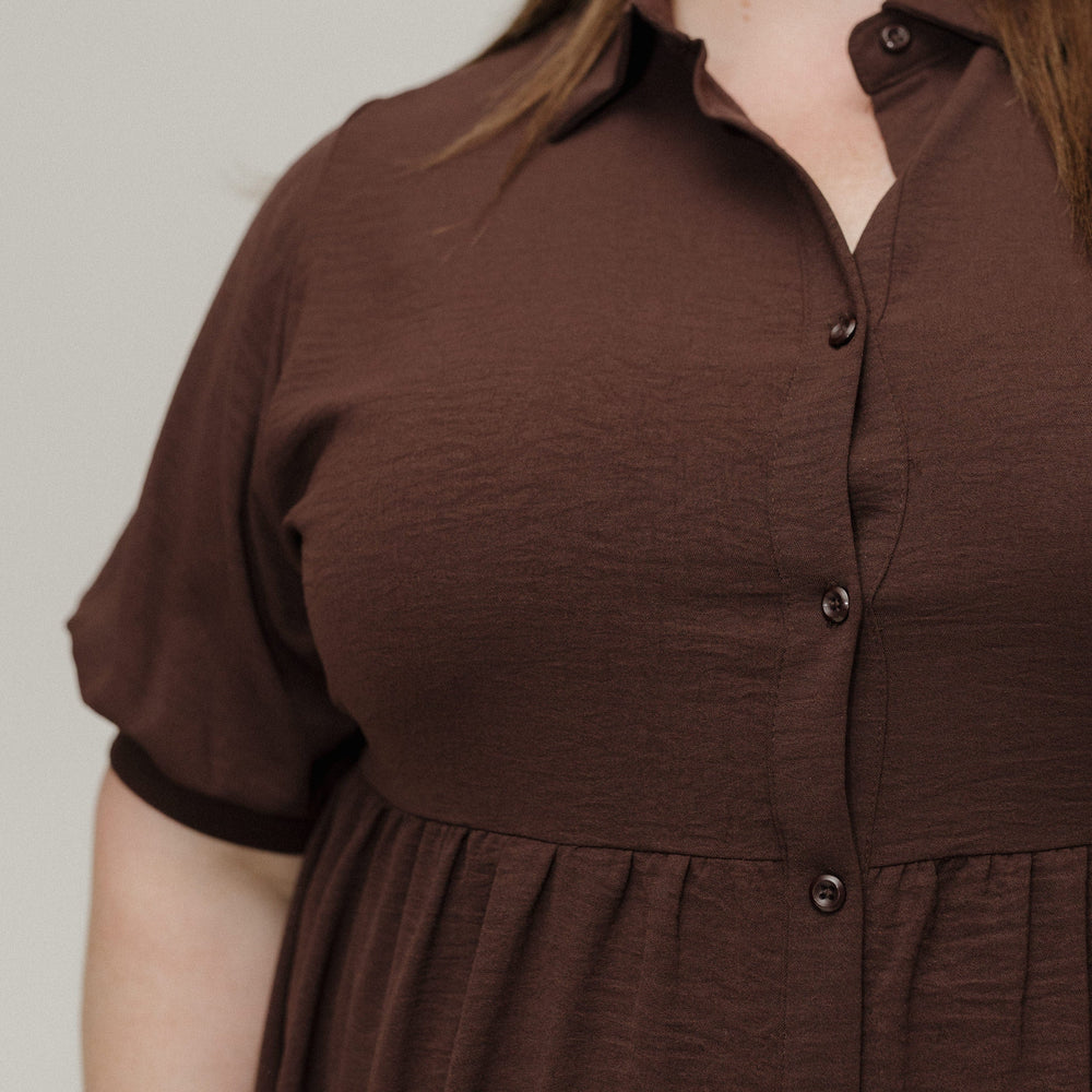 Brown dress worn by a person on a plain background