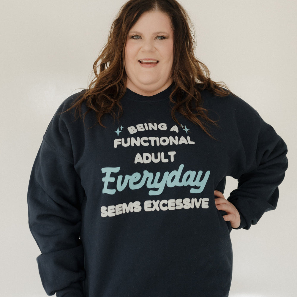 Person wearing a navy sweatshirt with humorous text design against a plain background