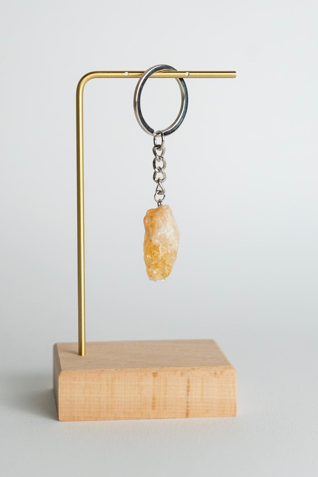Keychain with a stone pendant on a wooden stand against a light background