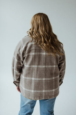 A person with long hair, wearing the CLASSIC SHACKET IN EARTH TONES by Yesta and jeans, is facing away.