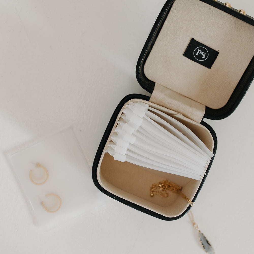 Open jewelry box with jewelry on a light background