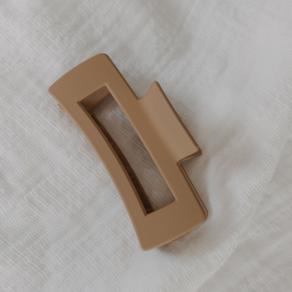 Cool Sand plastic clip on a white textured background