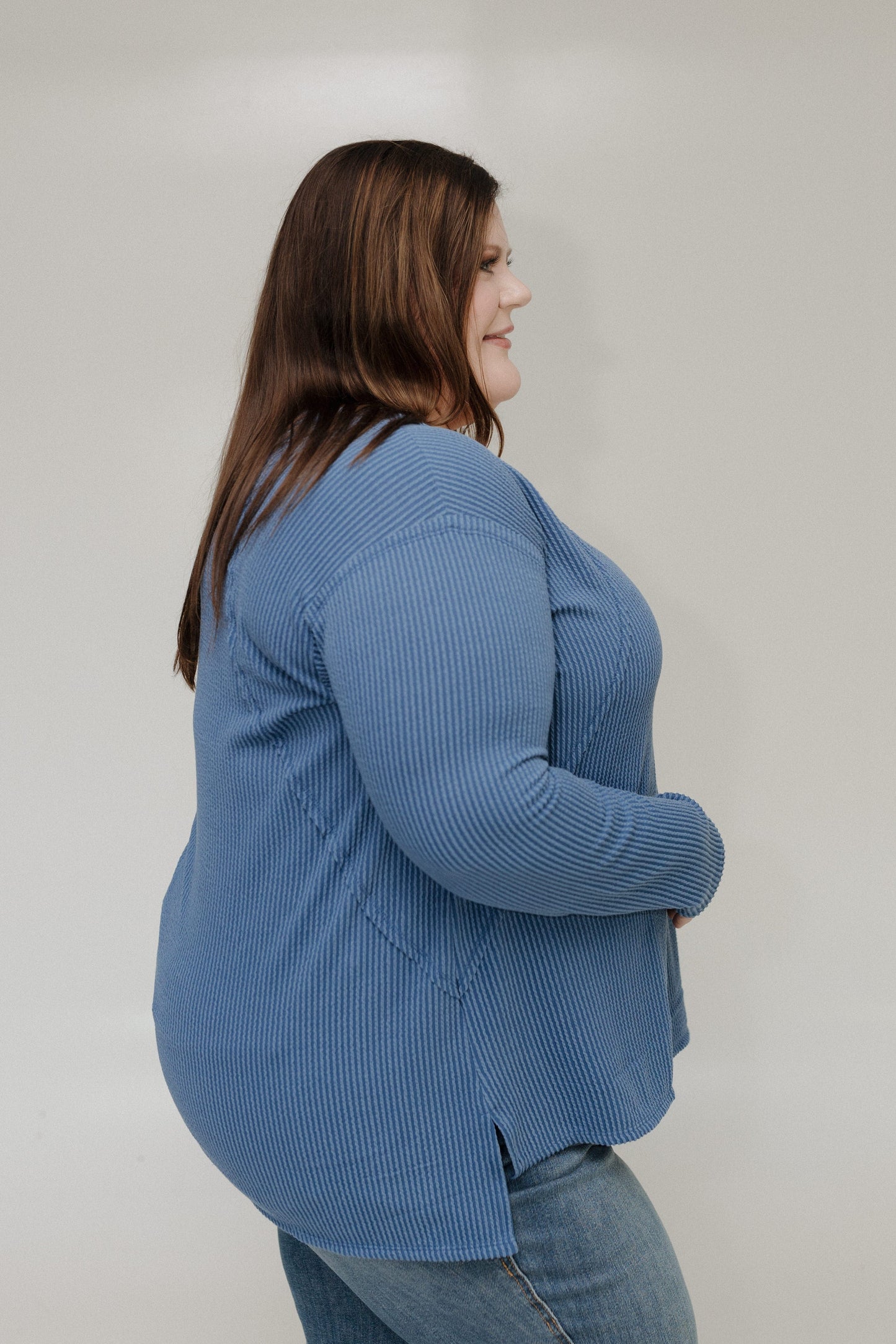 Woman wearing a blue tee against a plain background
