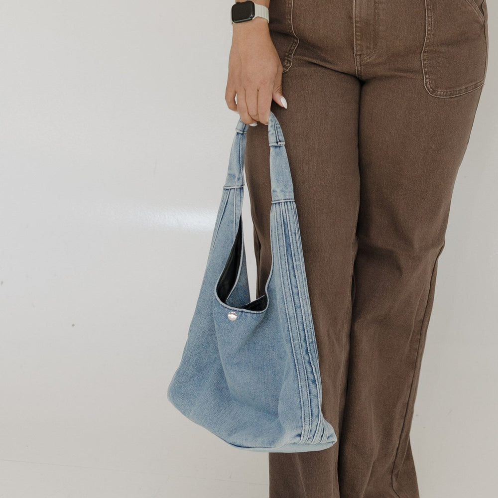 Trendy washed black denim for a casual-cool vibe Spacious interior for everyday essentials Front zipper pocket for easy access to must-haves
Comfortable hobo-style design for effortless wear Versatile and lightweight—perfect for any occasion

Upgrade your handbag collection with a laid-back yet stylish staple. Shop the Denim Dreamer Hobo Bag