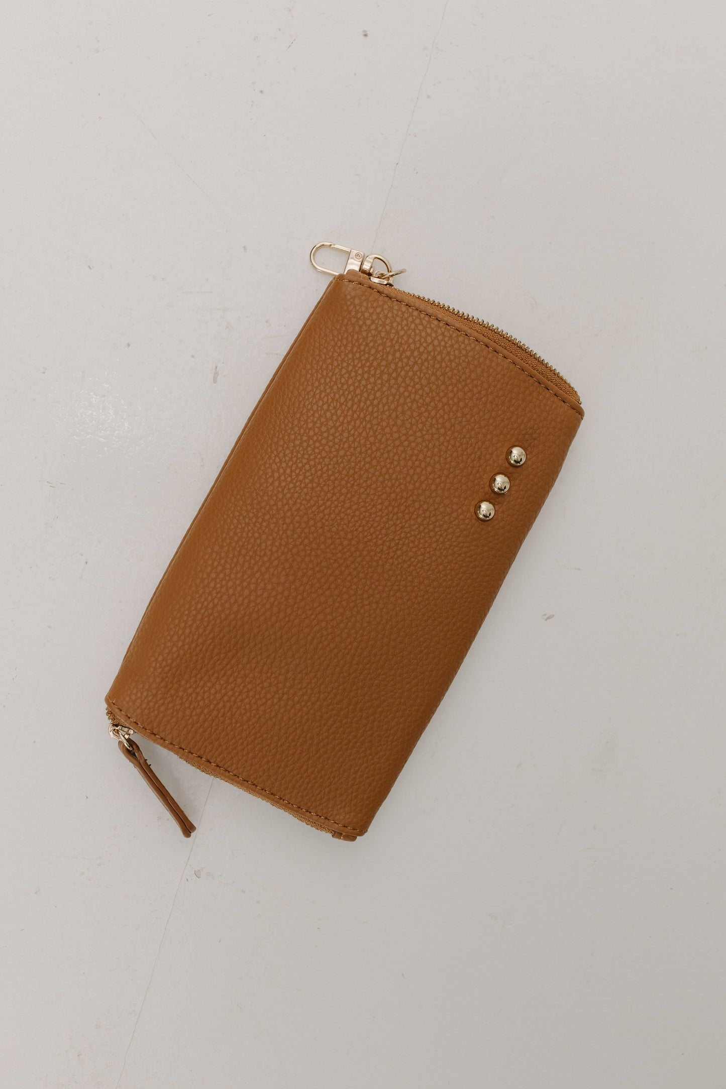 Brown leather case with a zipper on a white background