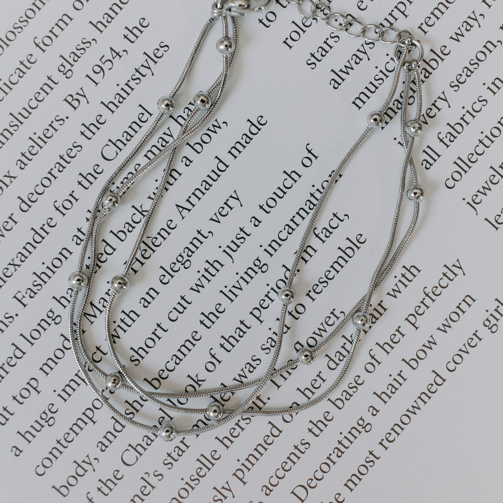 Silver bracelet on a piece of text
