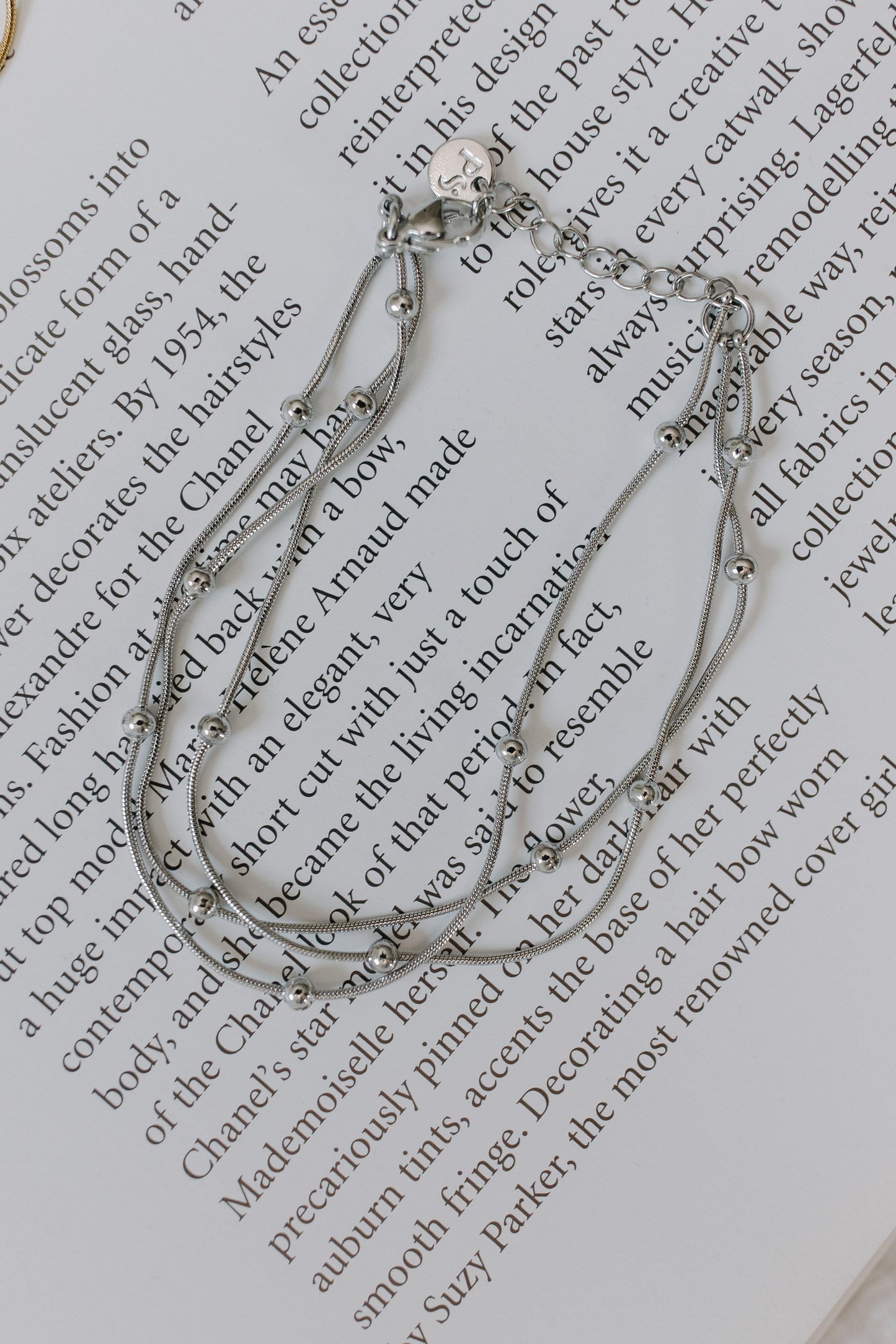 Silver bracelet on a piece of text