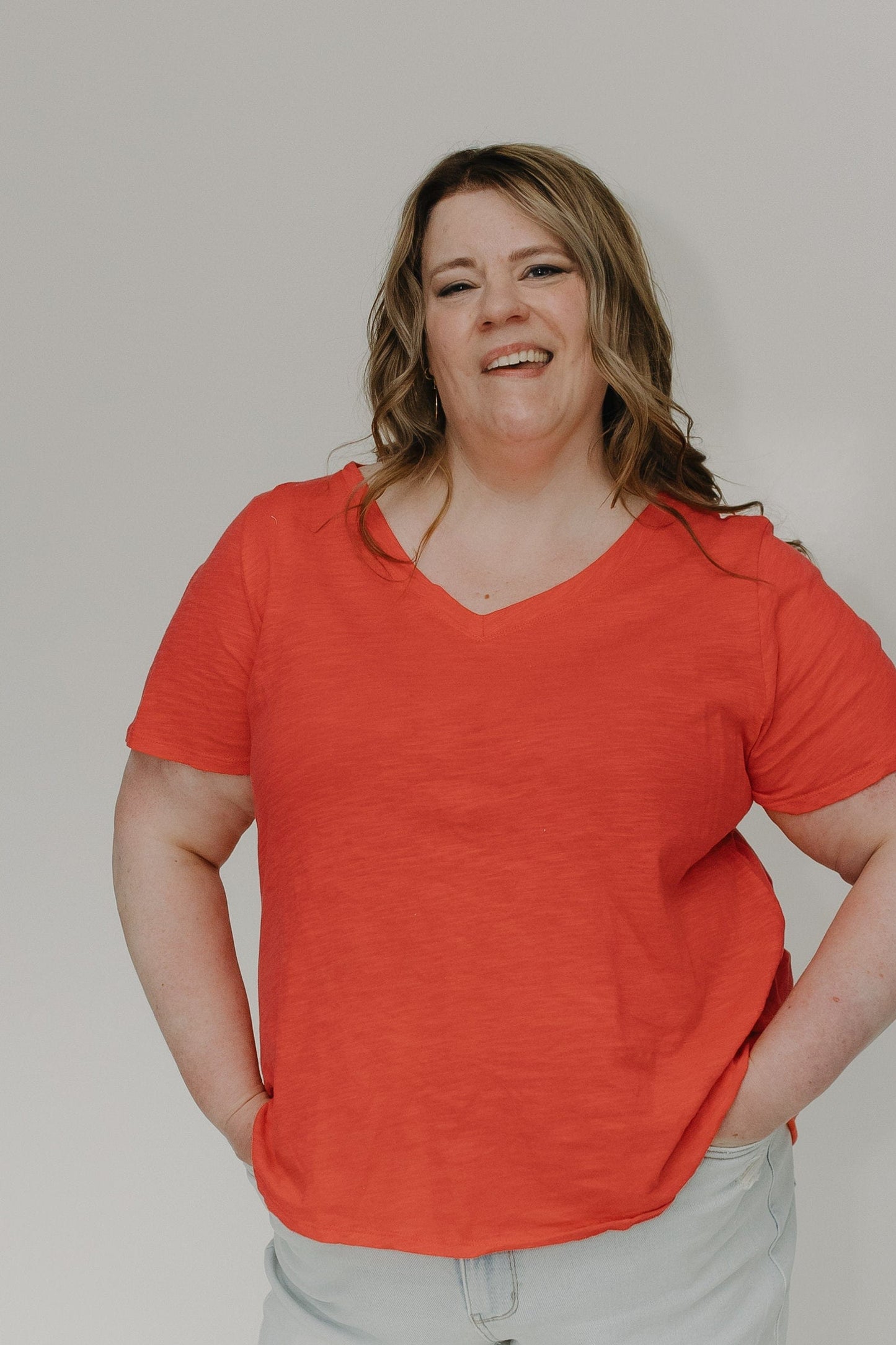 Person wearing a red shirt against a plain background