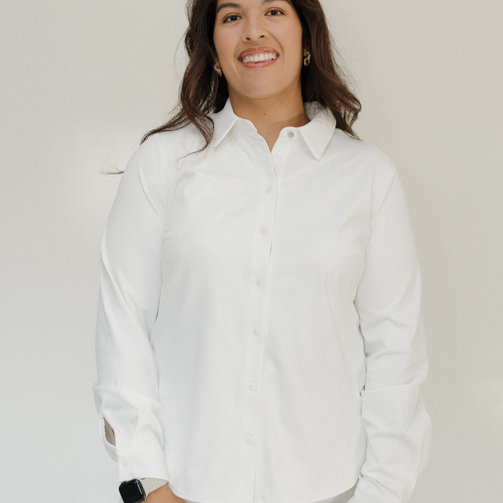Woman wearing a white shirt against a plain background