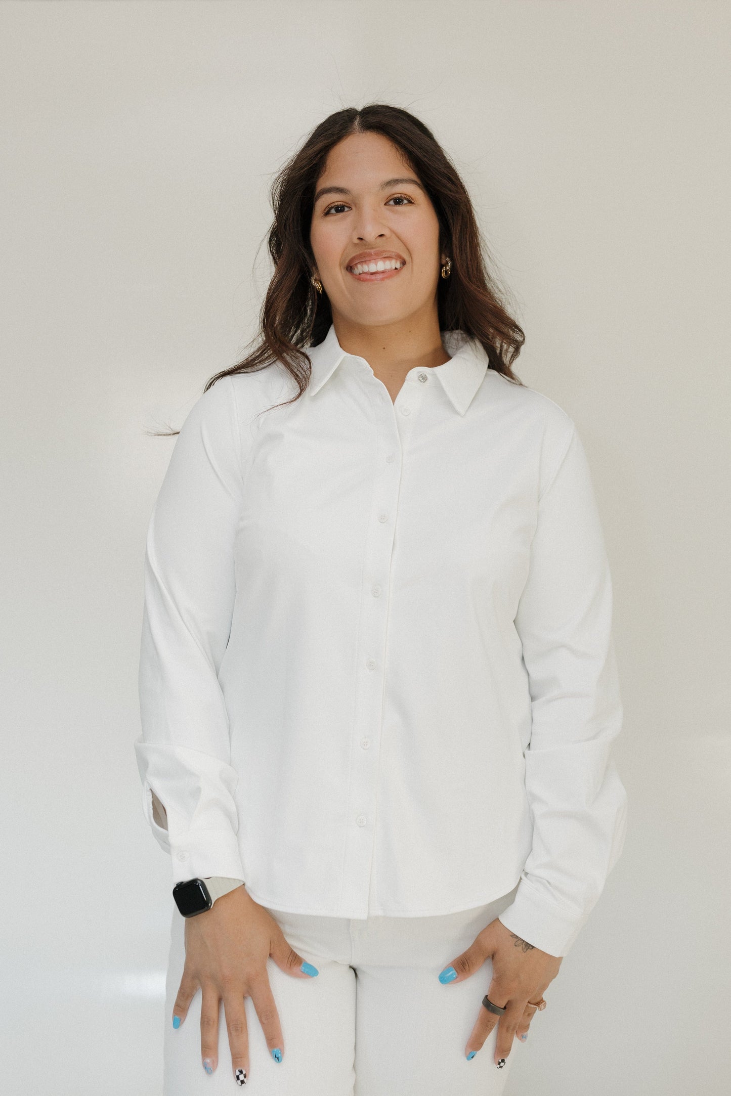 Woman wearing a white shirt against a plain background