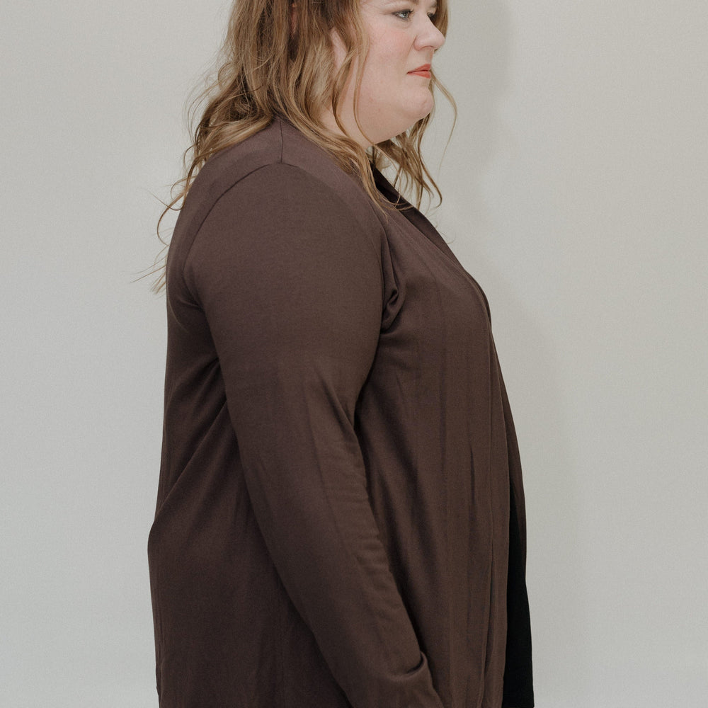 Woman wearing a brown outfit against a plain background