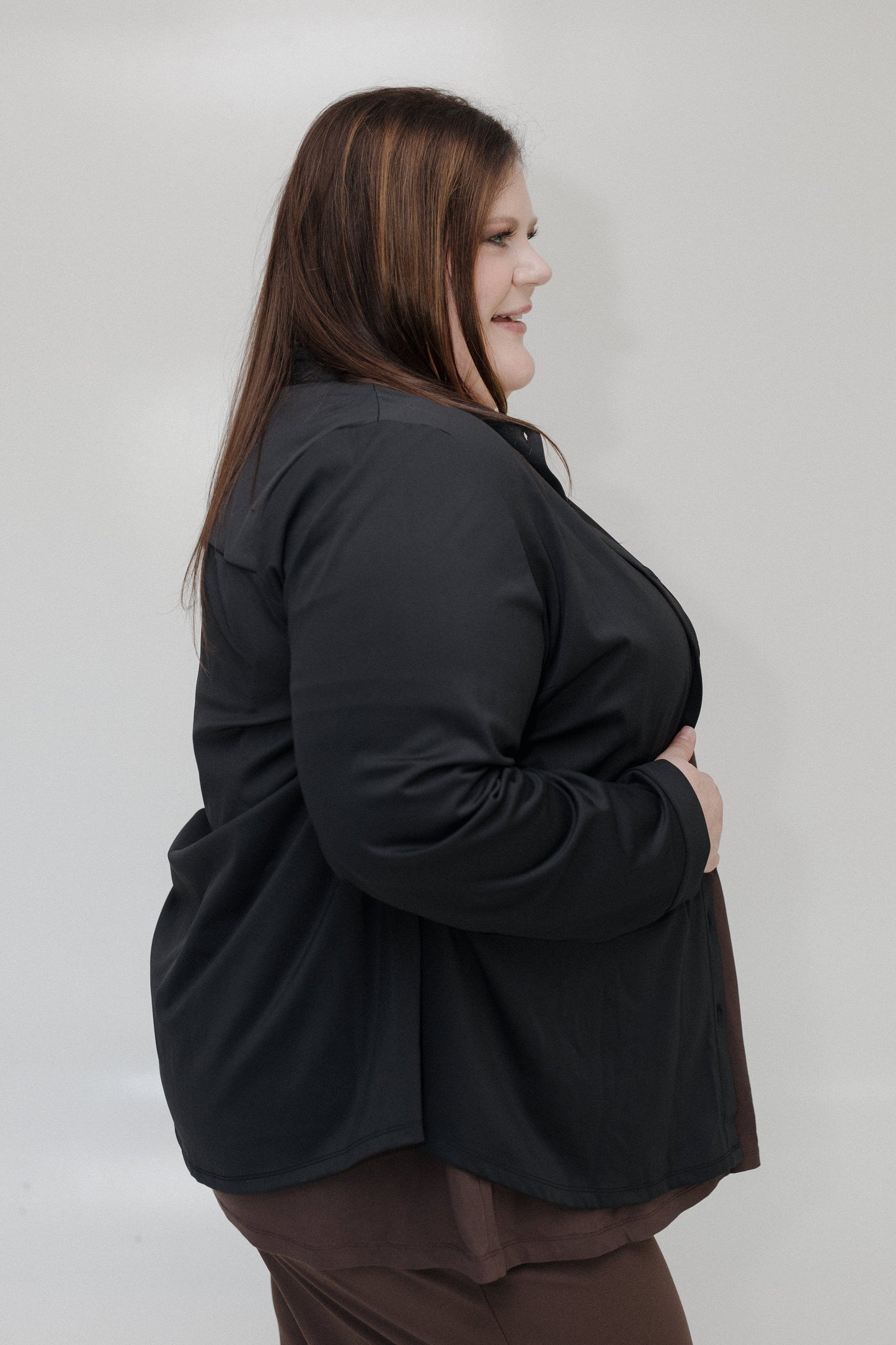 Person wearing a black jacket against a plain background