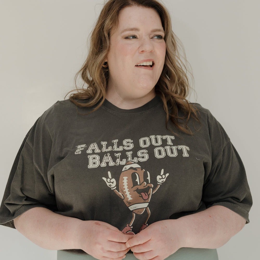 Person wearing a graphic t-shirt with text and design on a plain background