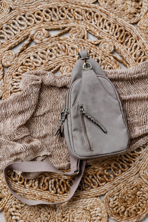 
            
                Load image into Gallery viewer, FAUX SUEDE SLING BAG IN CONCRETE
            
        
