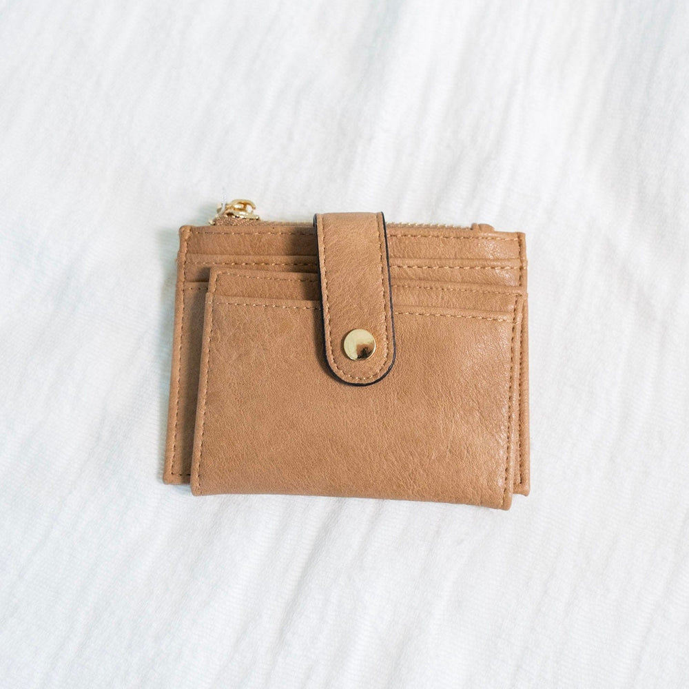 This stylish FAUX LEATHER WALLET IN MOCHA is perfect for carrying your cards and change while on the go. It features a fold-out design with a snap closure, card and ID slots, and a convenient zip change pocket. Enjoy quick access and organized storage with this classic wallet.