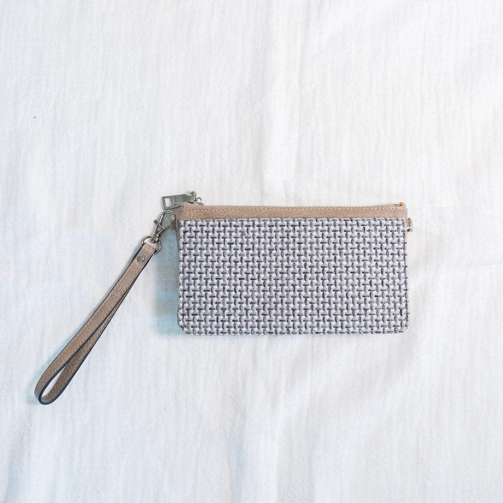 You'll make a statement with this woven flap wristlet! Plus, so much room for your cards and cash! Use this wristlet for a night on the town or running around town, and you'll love the grab-and-go quality of it! It has a zip closure, a detachable wrist strap, and supple faux leather. It is RFID protected! You will be protecting your personal data with the use of RFID blocking technology! A metal fiber mesh creates a "cage" around the chip on credit cards that radio waves cannot penetrate! Protect yourself a