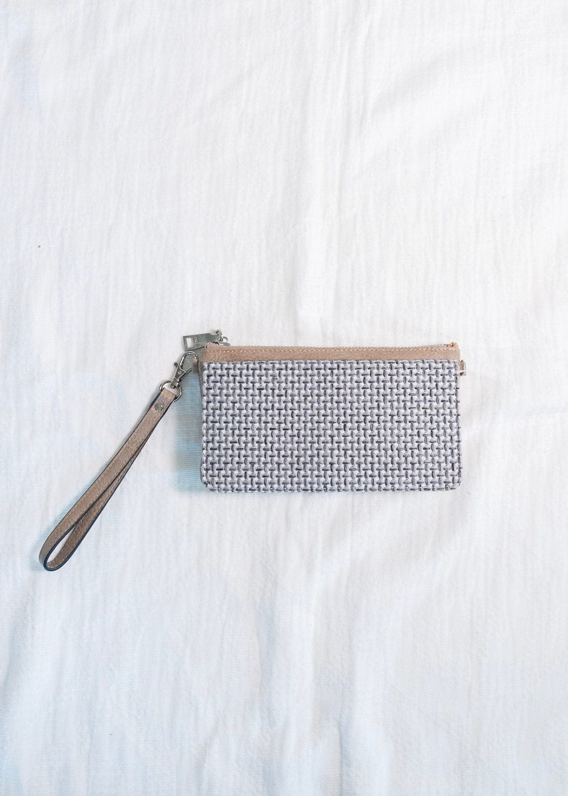 You'll make a statement with this woven flap wristlet! Plus, so much room for your cards and cash! Use this wristlet for a night on the town or running around town, and you'll love the grab-and-go quality of it! It has a zip closure, a detachable wrist strap, and supple faux leather. It is RFID protected! You will be protecting your personal data with the use of RFID blocking technology! A metal fiber mesh creates a "cage" around the chip on credit cards that radio waves cannot penetrate! Protect yourself a