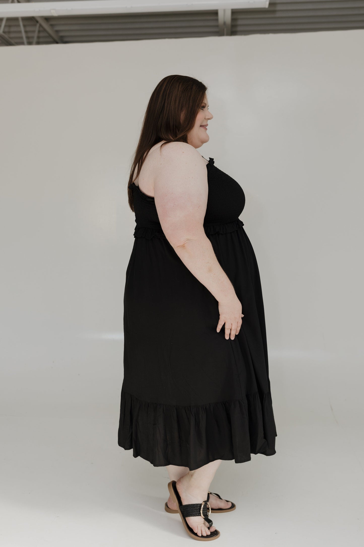 Woman wearing a black dress against a white background