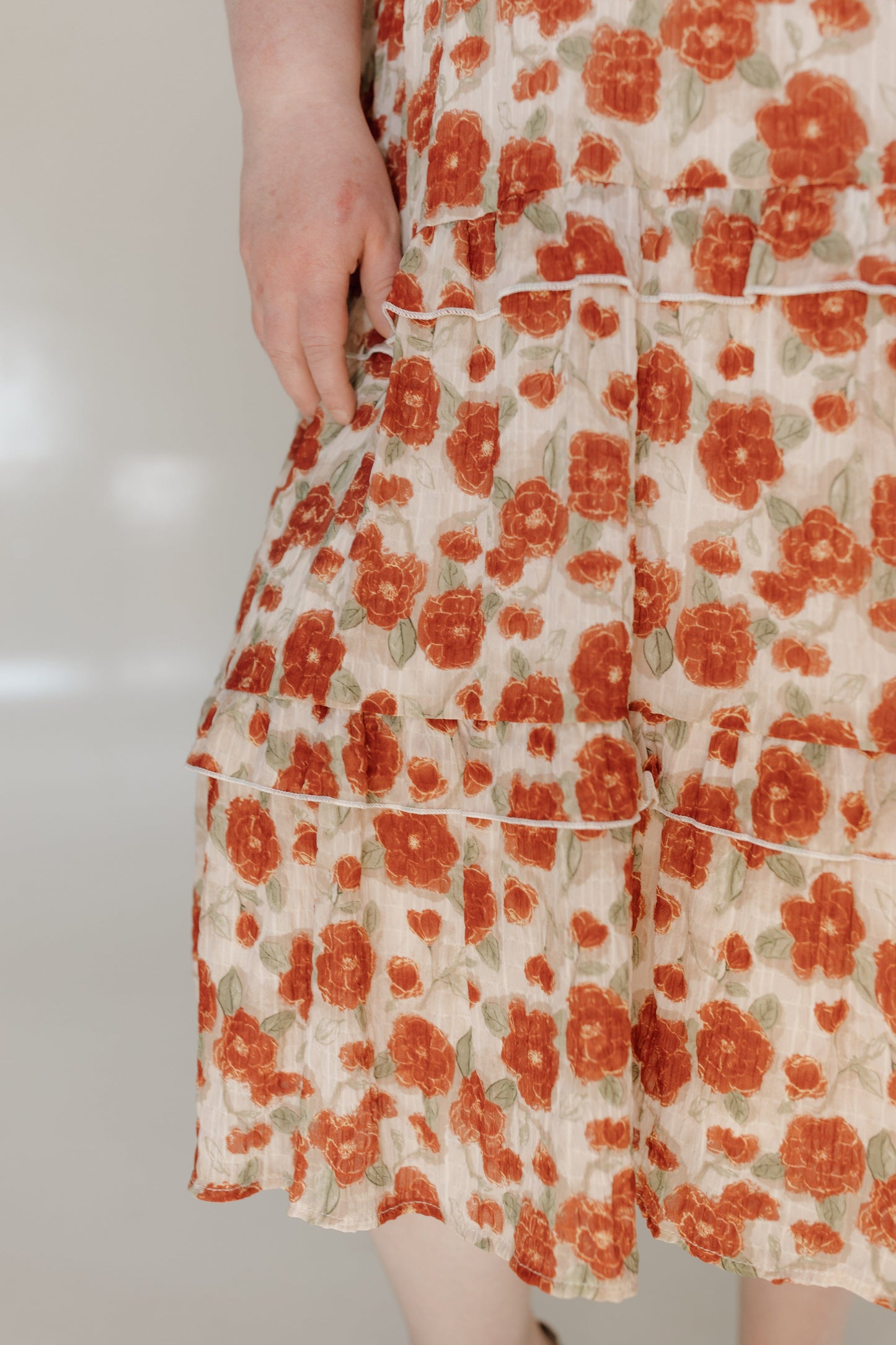 Floral dress with orange flowers on a plain background