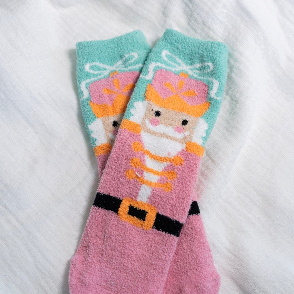 Pair of socks with a nutcracker character design on a white background