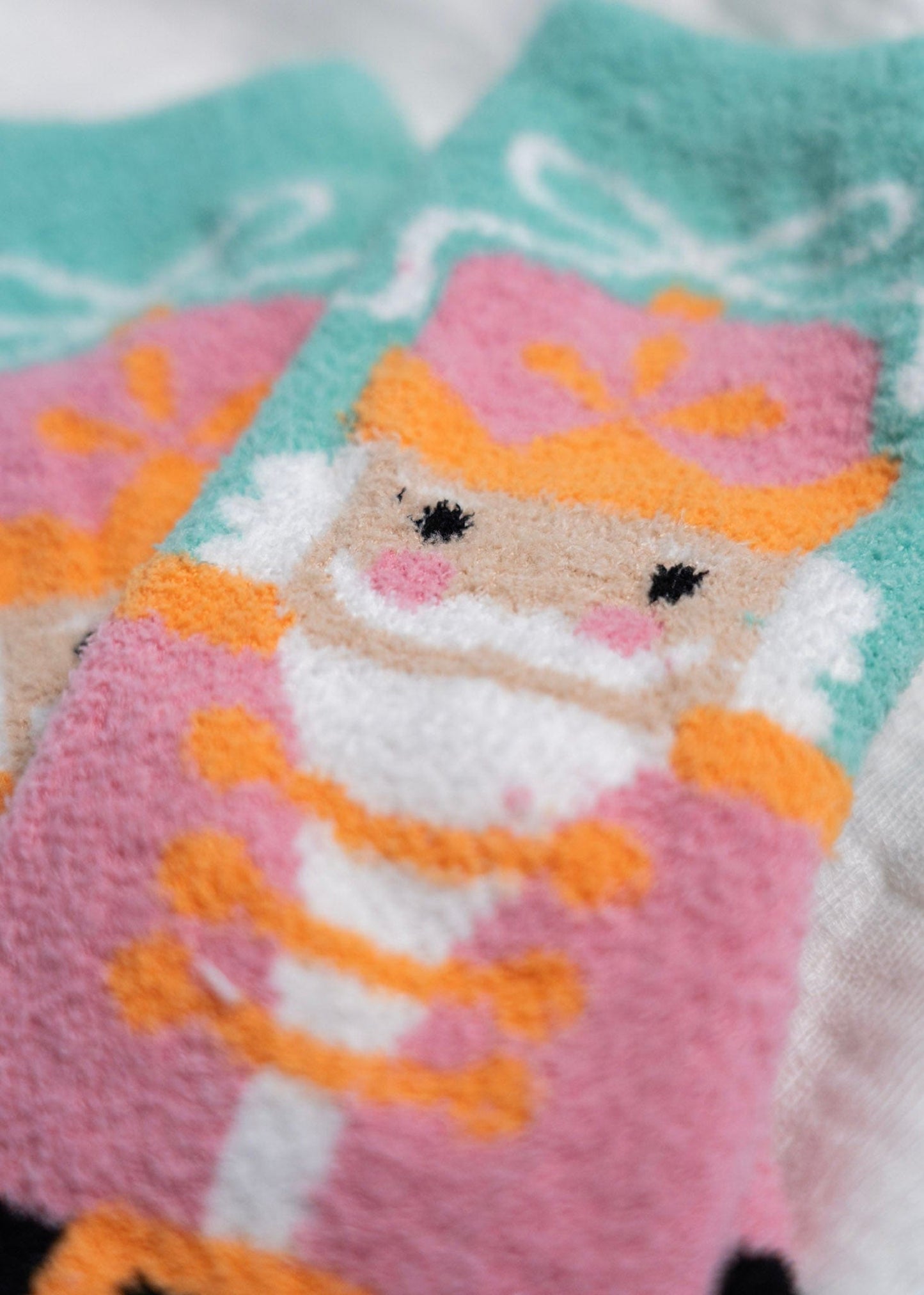 Knitted socks with a nutcracker character design on a light blue background