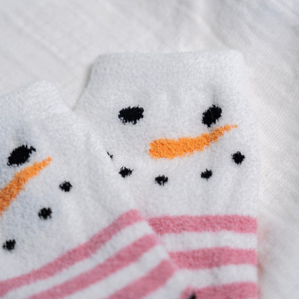 Close-up of a snowman-themed socks with pink and white stripes.