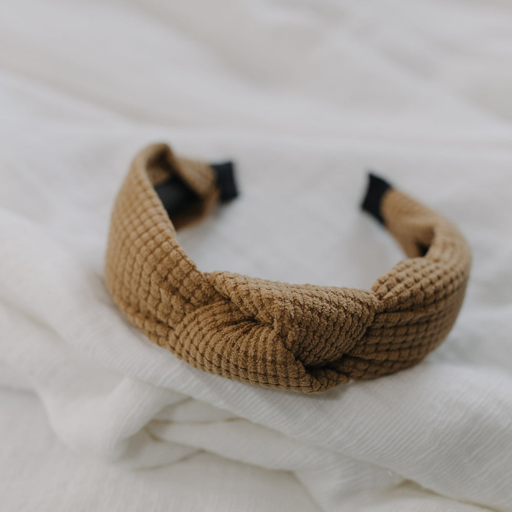 Golden wheat waffle texture headband against a white background