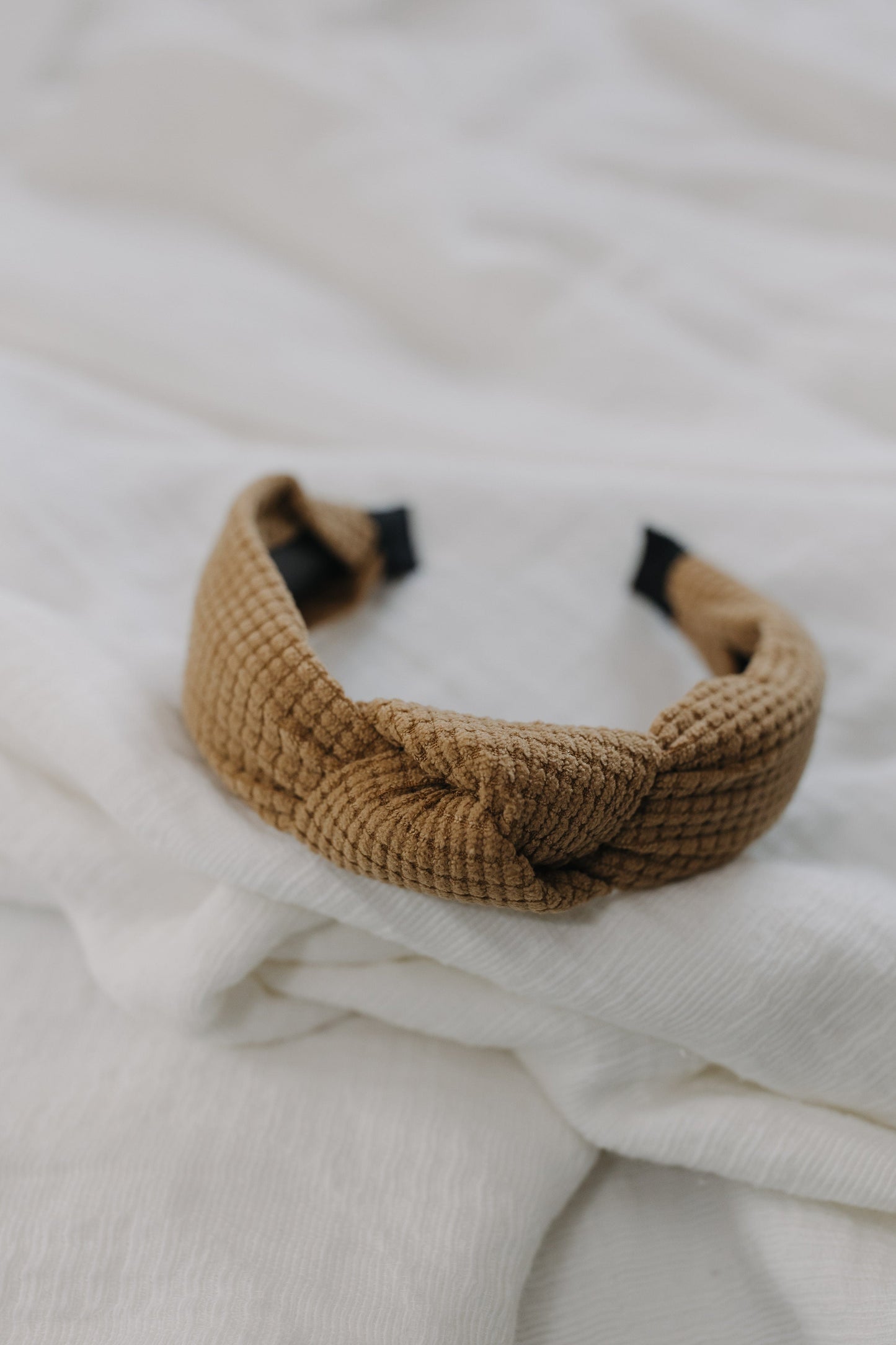 Golden wheat waffle texture headband against a white background